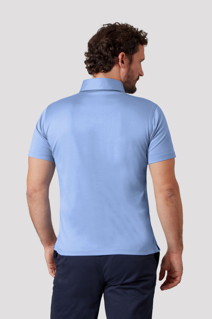 Rear view of model wearing men's blue polo shirt made from Egyptian cotton