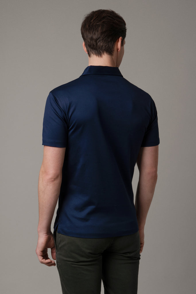 Rear view of model wearing men's Inkwell Navy polo shirt made from Egyptian cotton