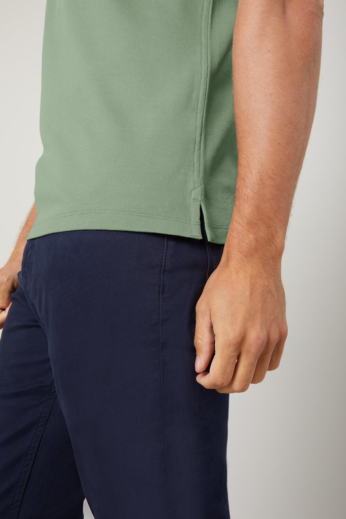Side view of model wearing men's Jade Green polo shirt made from Egyptian cotton