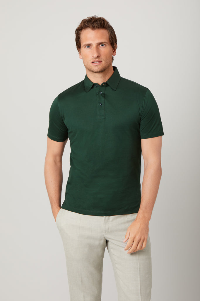 Front view of model wearing men's Racing Green polo shirt made from Supima cotton