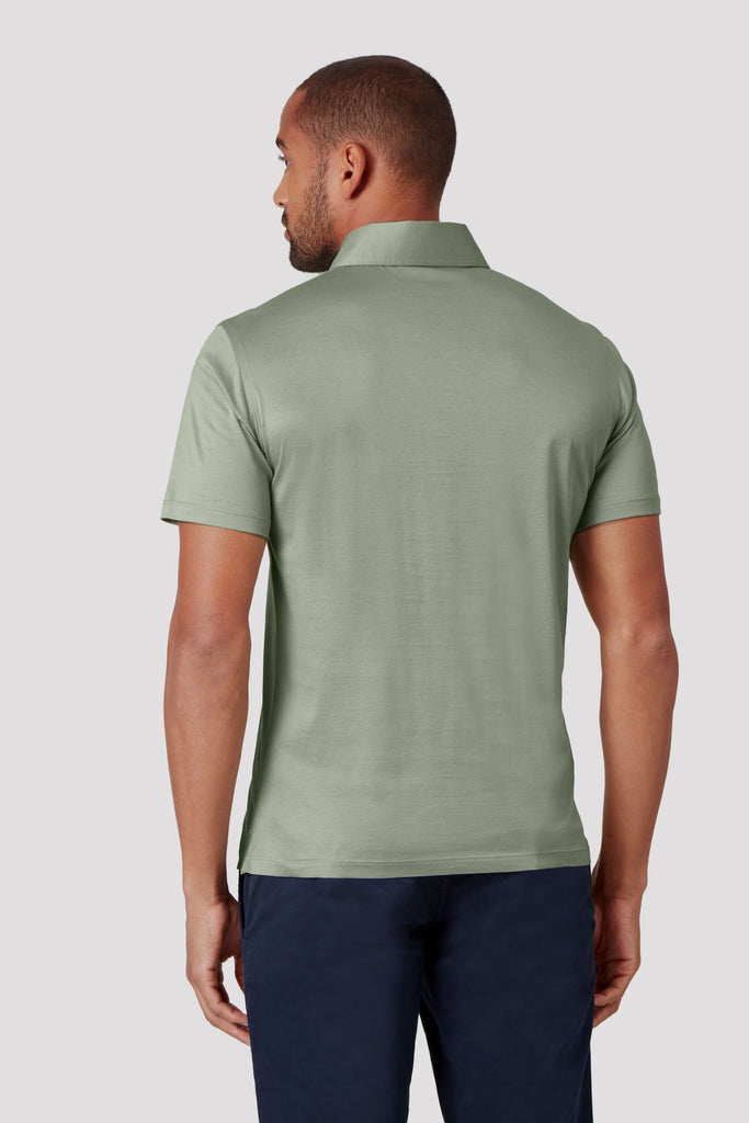 Rear view of model wearing men's Tuscan Sage Green polo shirt made from Sea Island cotton