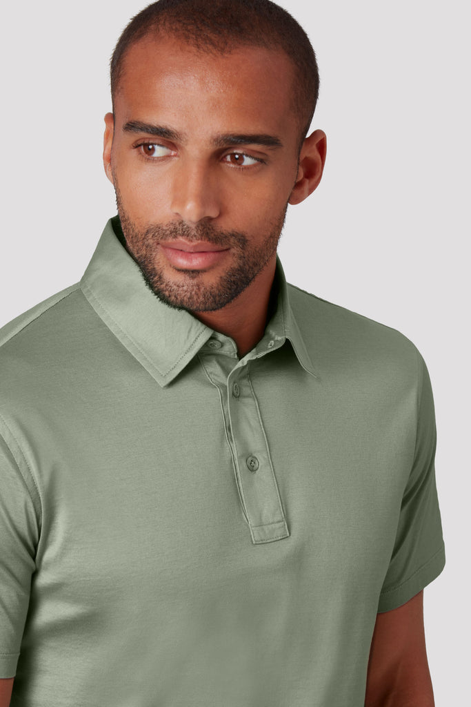 Close-up of model wearing men's Tuscan Sage Green polo shirt made from Sea Island cotton